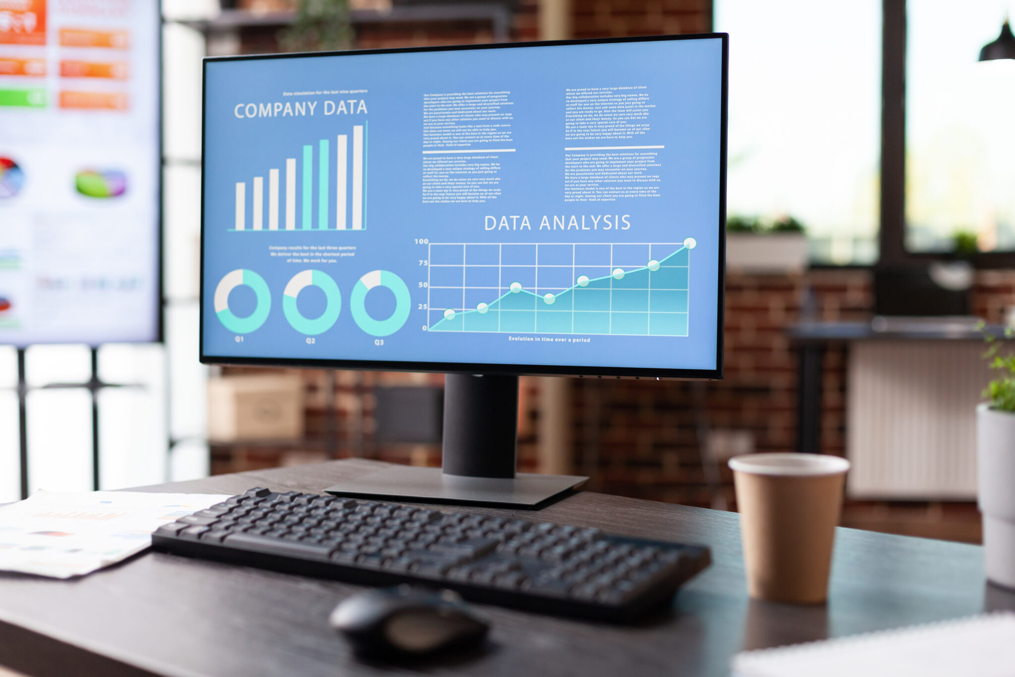 A monitor displaying graphs on a desk, representing Excell Digital Marketing Services' data analysis and performance metrics