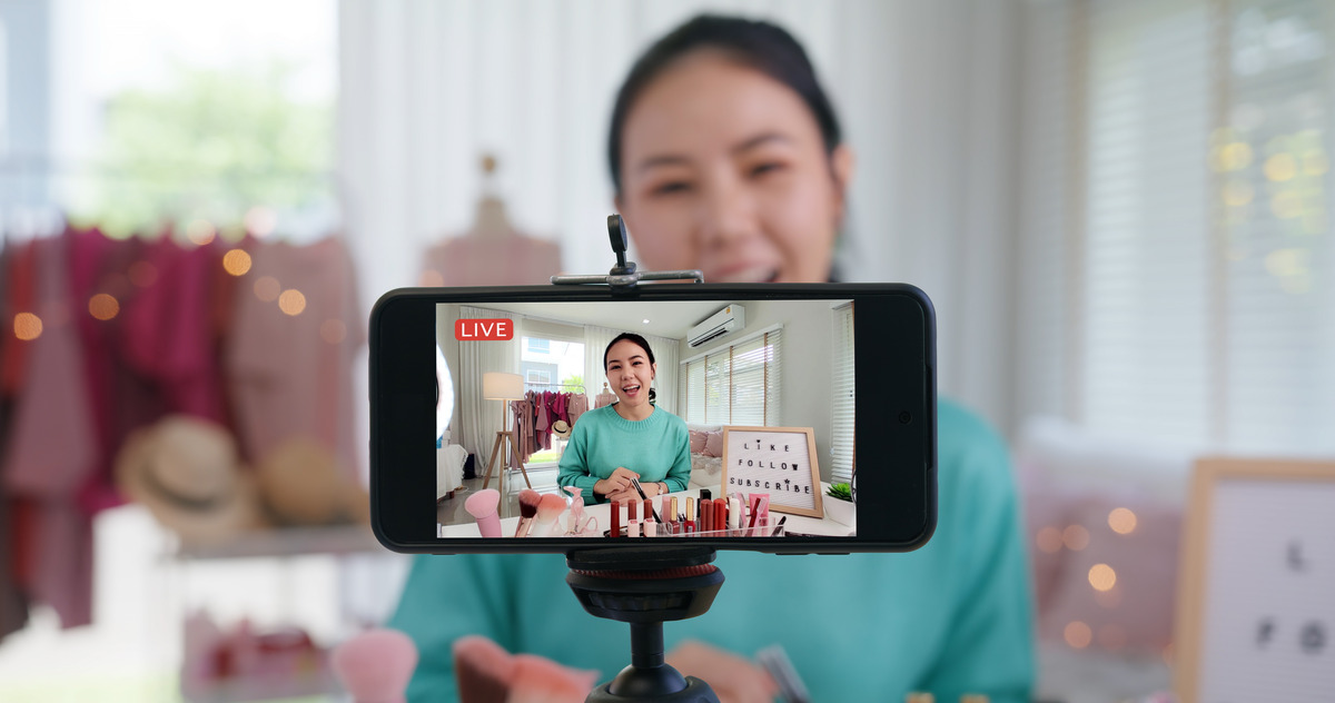 A woman captures a selfie with her phone, smiling and enjoying the moment
