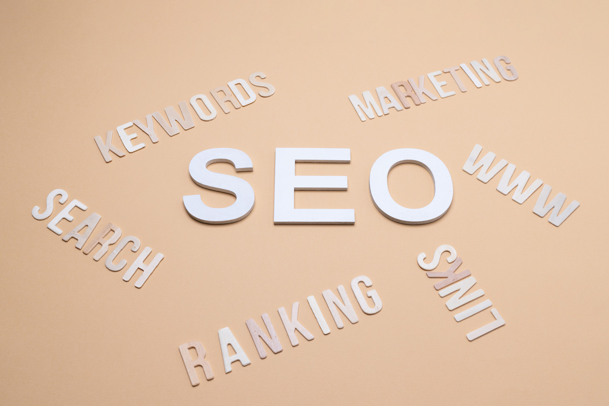 Word cloud on beige background highlighting key SEO terms, emphasizing best quarterly reports for clients