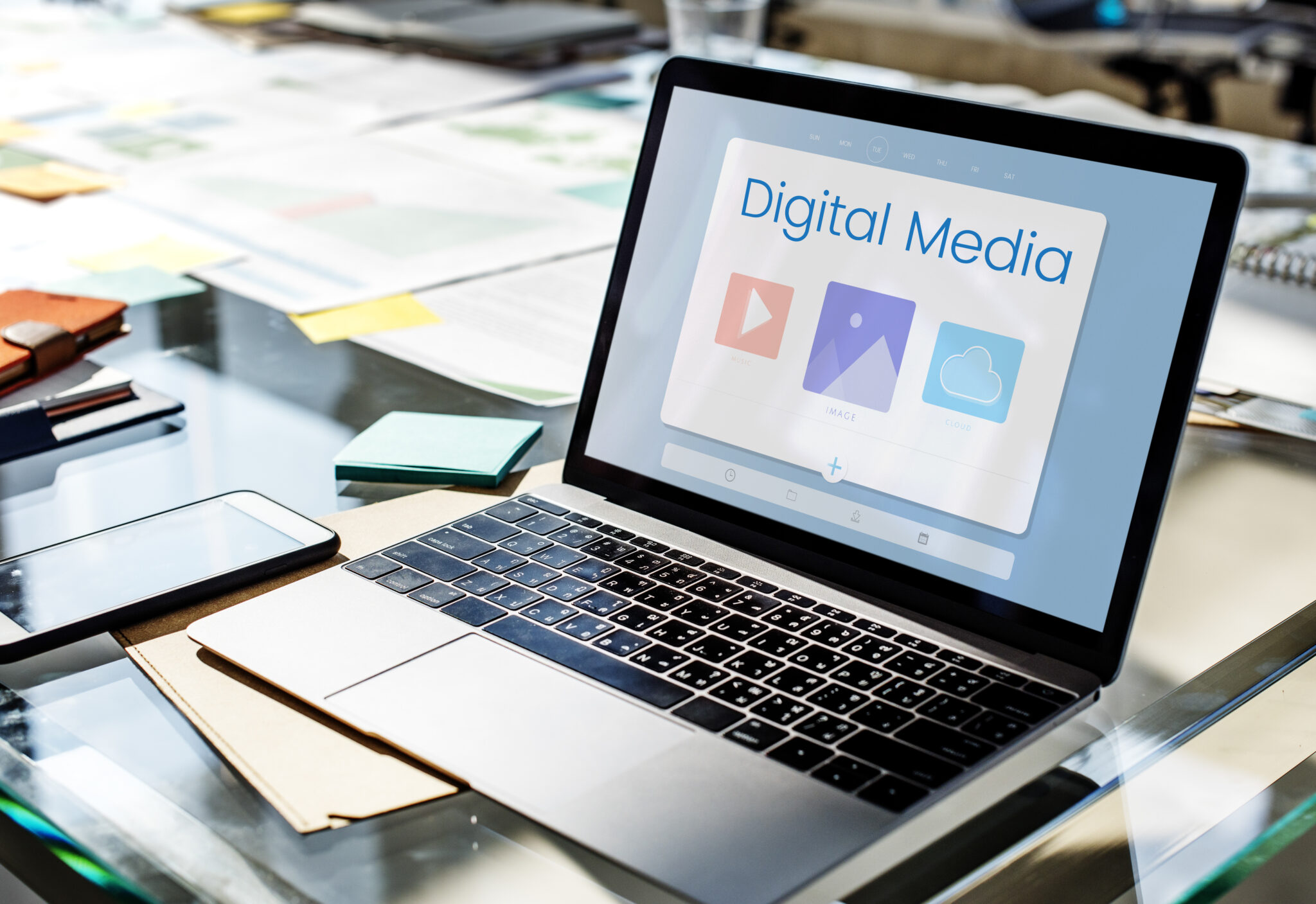 Laptop displaying a digital media platform on a modern office desk, representing digital marketing strategy, online content creation, and cloud storage solutions