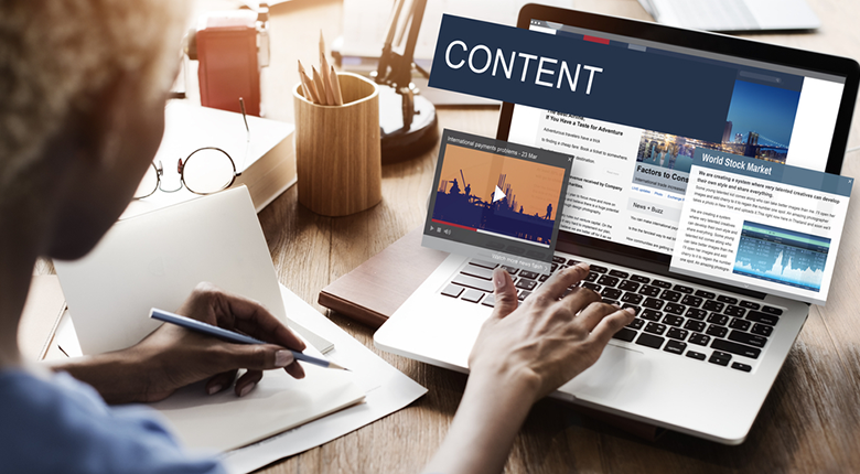 Digital content strategy concept showing a workspace with a laptop, open notebook, and interactive graphics for video and news conten