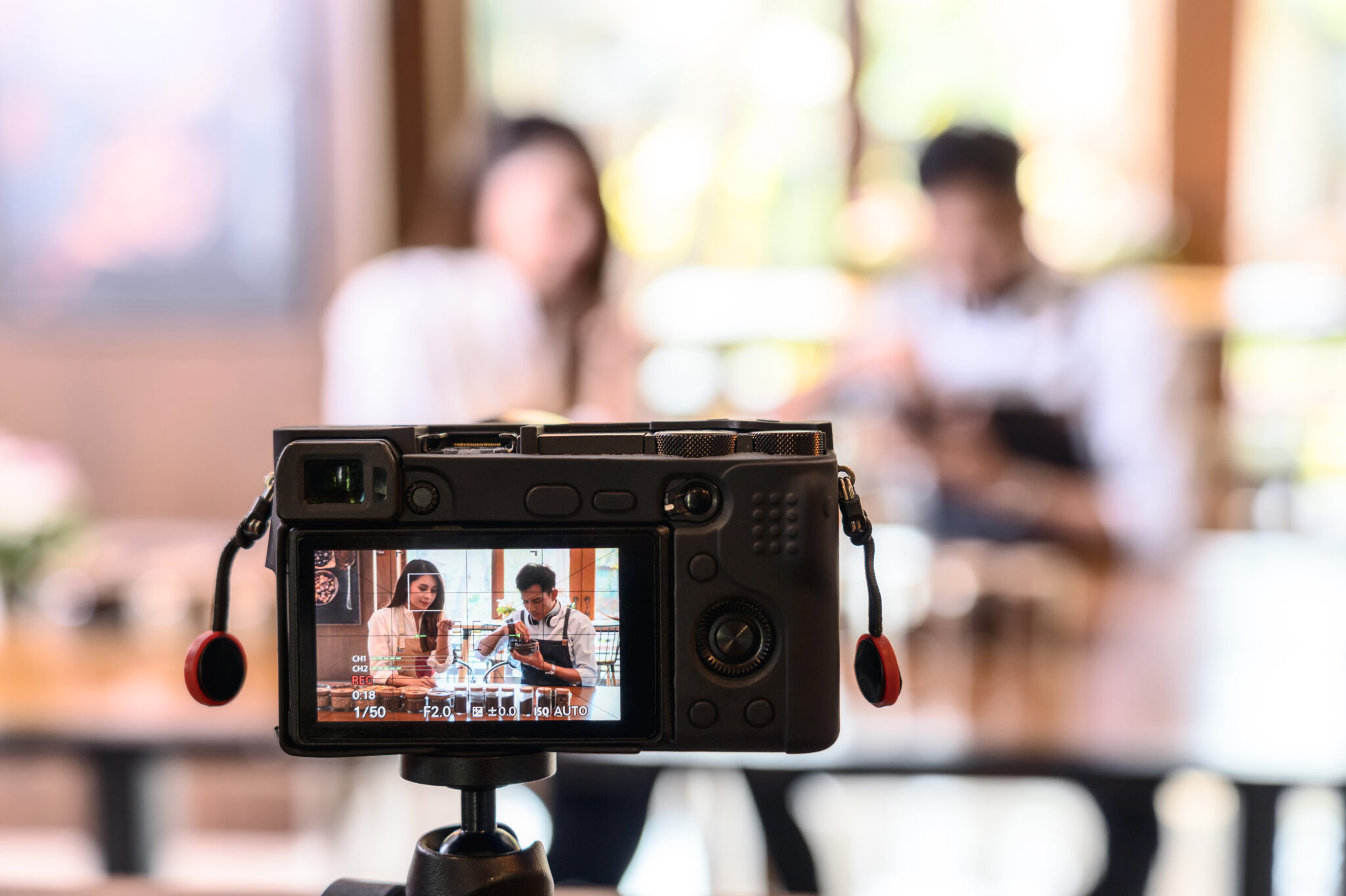 Camera recording a YouTube video in a cafe setting, ideal for showcasing business expertise through video content