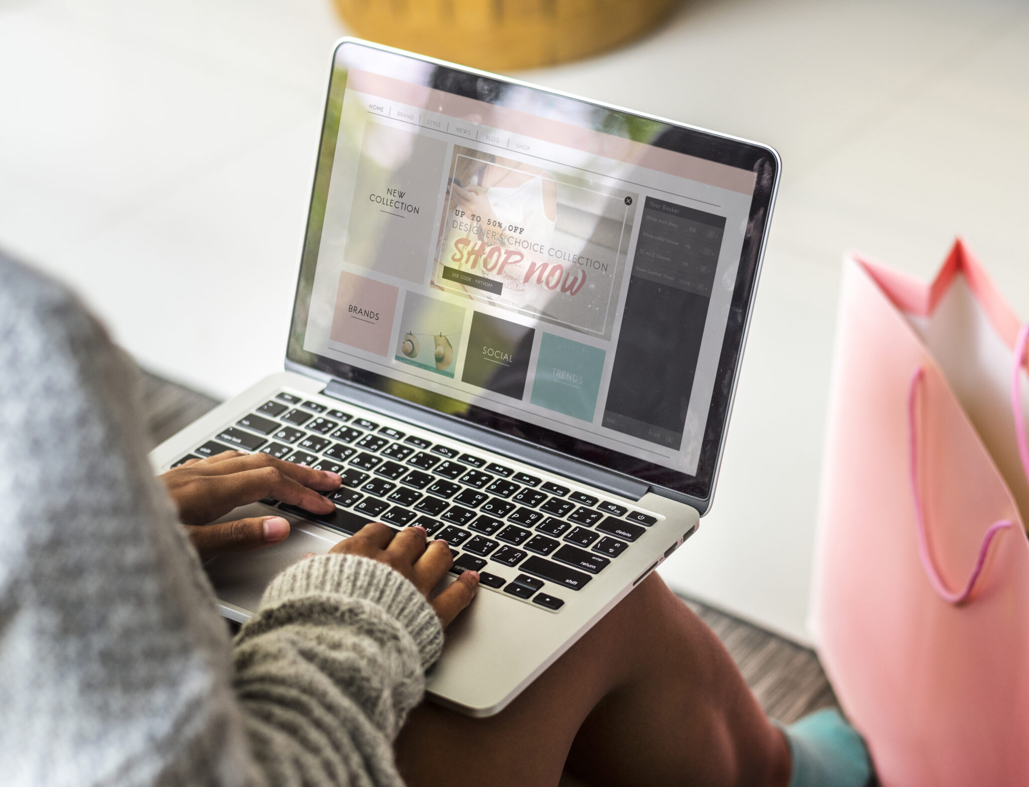 Person updating website content on a laptop to ensure fresh and relevant information, crucial for improving search engine rankings