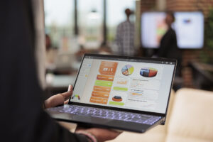 A person analyzing a digital marketing dashboard on a laptop, strategizing during an economic recession