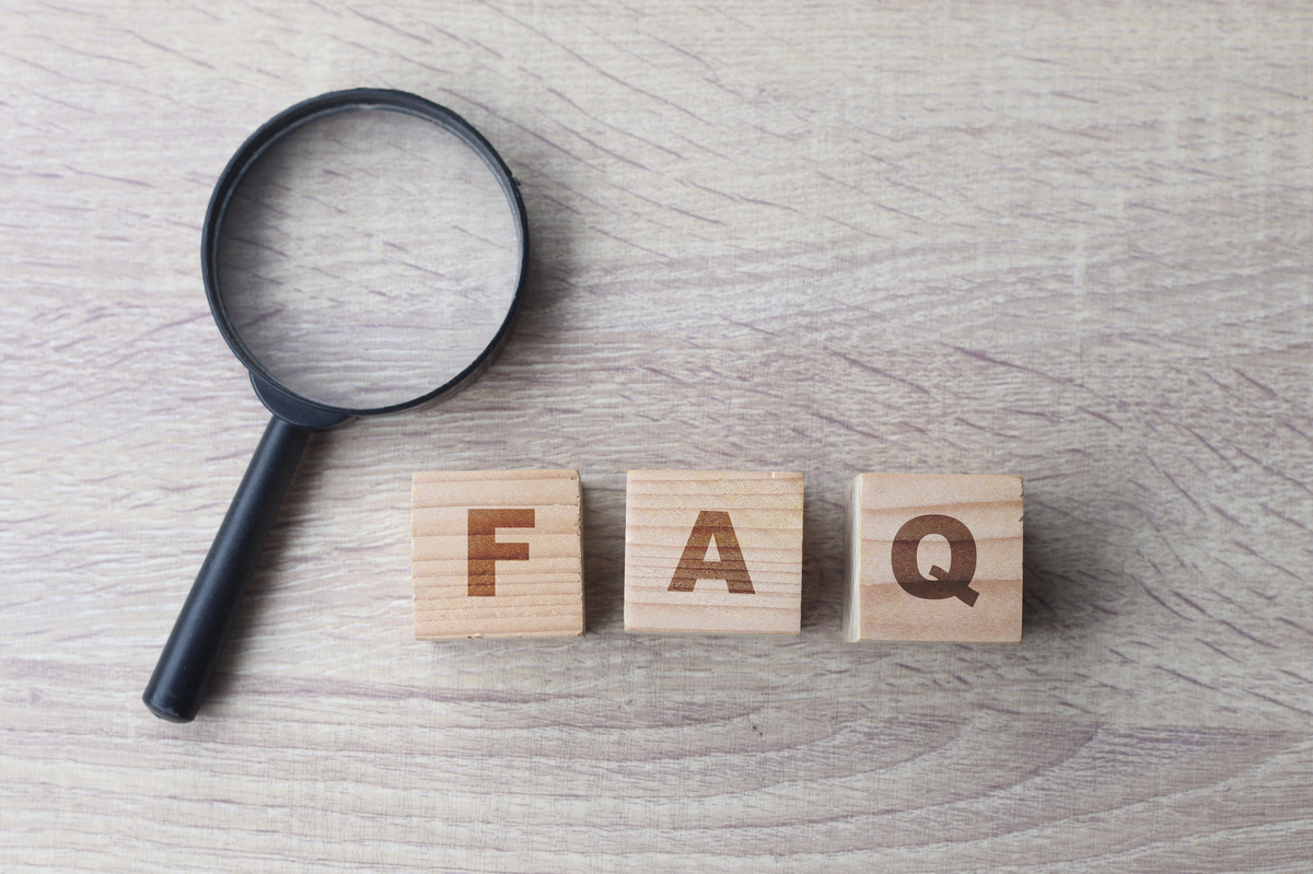 FAQ letter blocks with magnifying glass