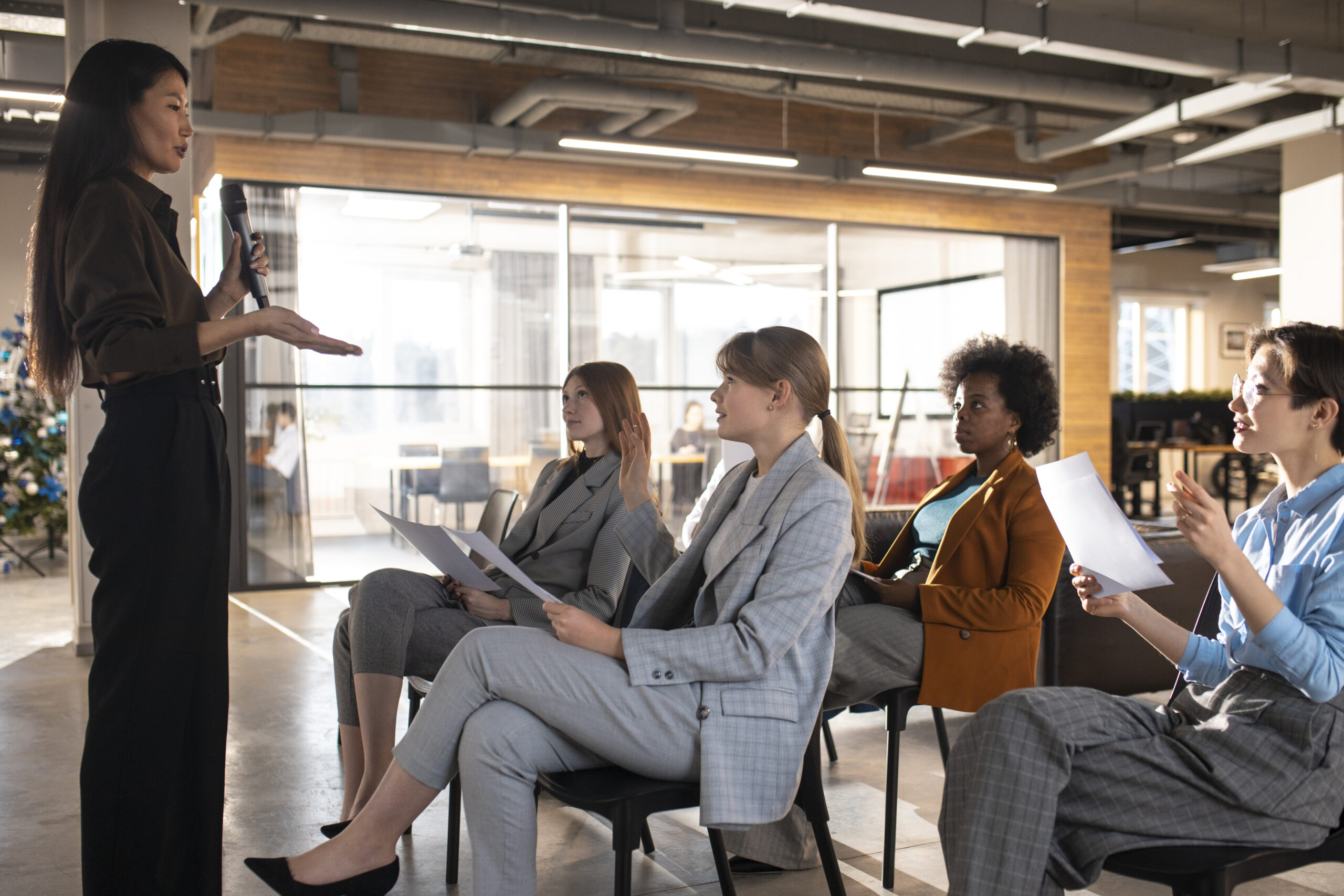 Business speaker giving a presentation to a diverse group of employees during a corporate training session