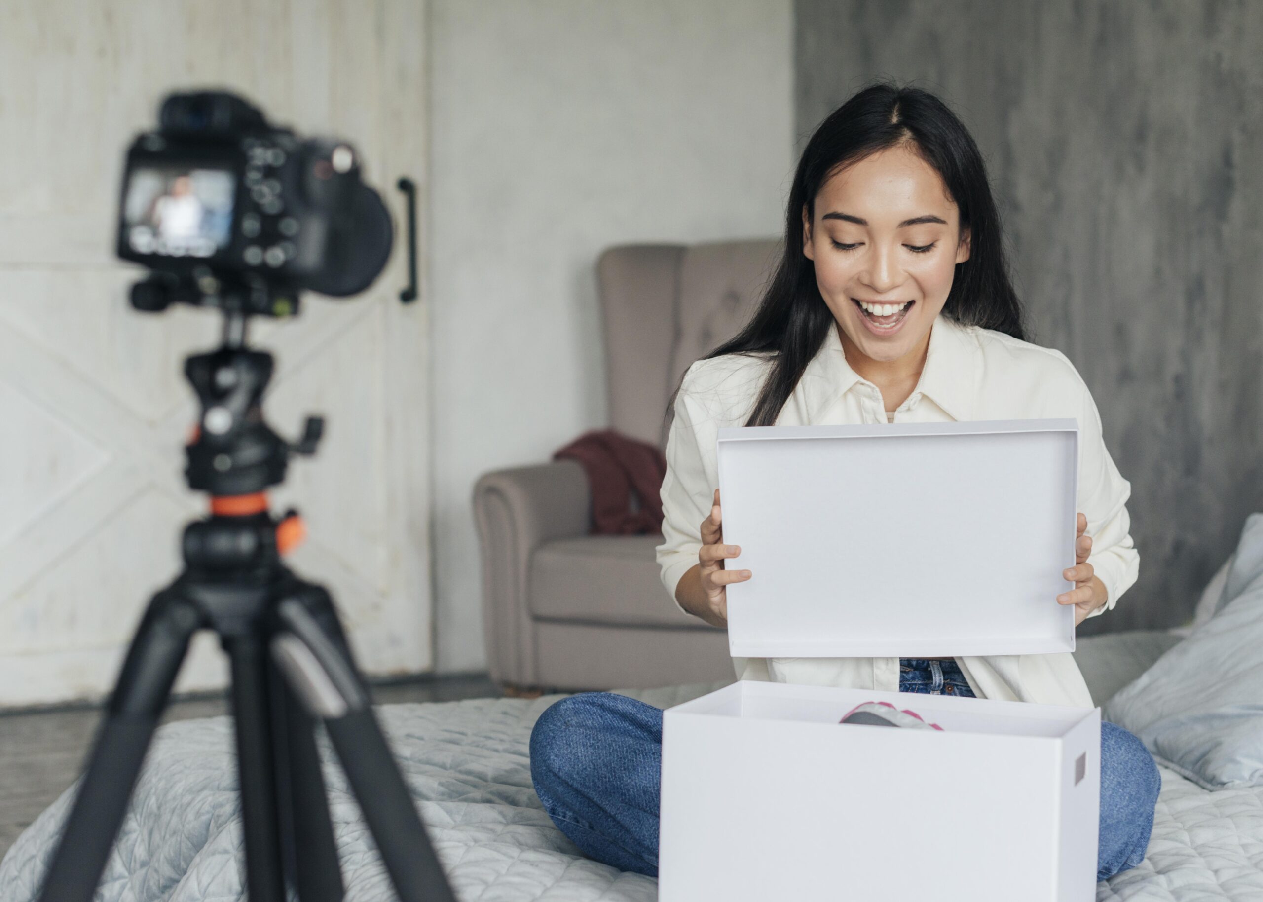 young-woman-surprised-by-new-shoes Creator making content for a product review or haul video, illustrating the customer experience of receiving and unboxing an e-commerce order